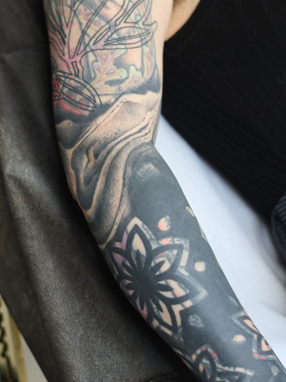 black and geometric blast over tattoo sleeve cover up by matt hunt in the UK